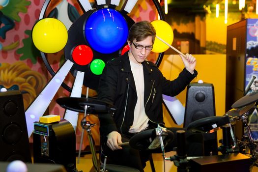 Young man playing on the electronic drums