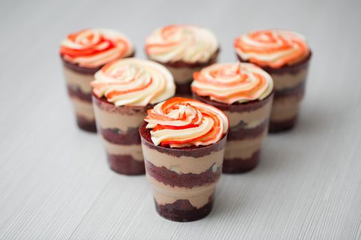 Chocolate and mousse trifle dessert in plastic cups.