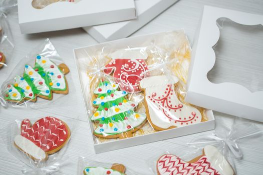 A box with Christmas gingerbread on a wooden background.