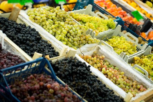 Some red and green grapes for sale at the supermarket