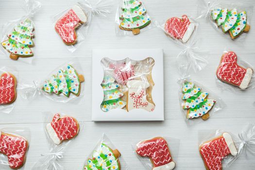 A box with Christmas gingerbread on a wooden background.