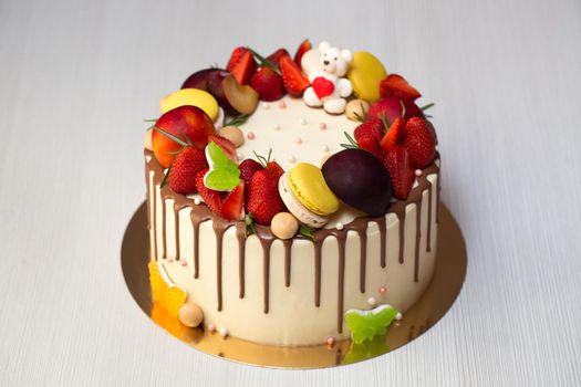 A bright cake with strawberries and chocolate streaks.