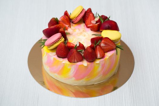 Cake yellow and pink splotches, strawberries, peaches, macaroons rosemary