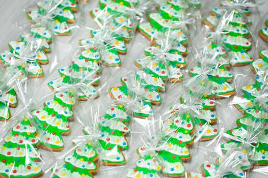 Gingerbread in the shape of a Christmas tree on a white background.