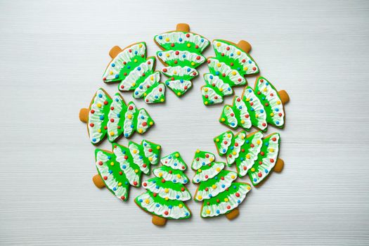 Gingerbread in the shape of a Christmas tree on a white background.