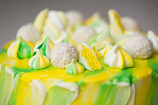 Cake watercolor painting of yellow and green color with a meringue, sweets and marshmallows