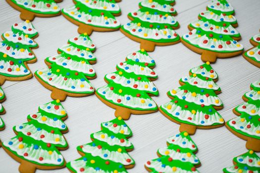 Gingerbread in the shape of a Christmas tree on a white background.