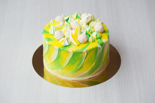 Cake watercolor painting of yellow and green color with a meringue, sweets and marshmallows