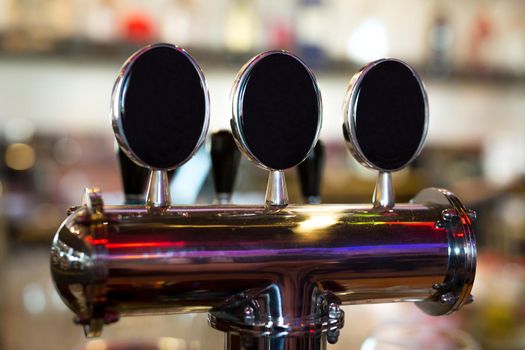 Beer on tap in a pub in a row.