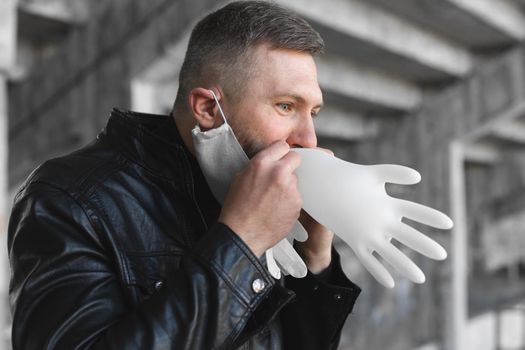 Man before putting on medical gloves inflates them