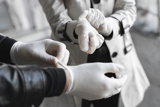 Man and woman wears medical gloves to be safe from the outbreak of novel coronavirus.Wearing hand gloves can prevent the covid-19 coronavirus.