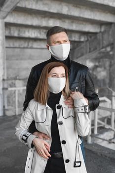 A masked man and woman embrace. Coronavirus. Covid19.