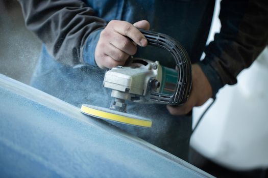 Sanding polishing of the bumper on the car at a hundred close-up.