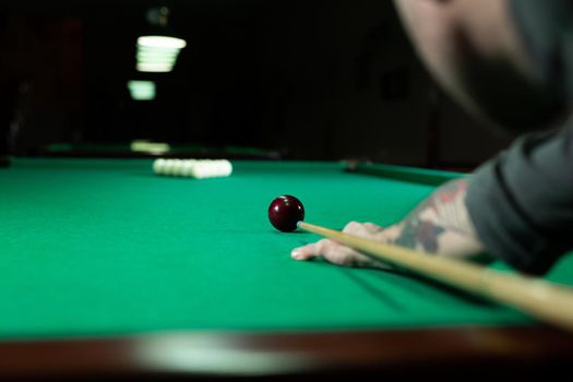 Rear view of man aiming the billiard ball with cue