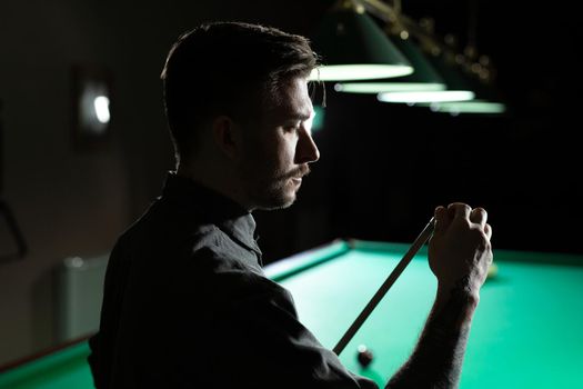 Close up of a unrecognizable man chalking pool cue