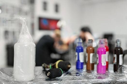 Many professional bottles with colored ink for tattoos.