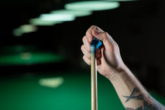 Close up of a unrecognizable man chalking pool cue