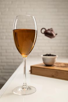 table with appliances and a wine glass in which tea is brewed