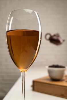 table with appliances and a wine glass in which tea is brewed