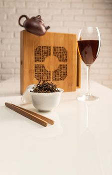 tea table with appliances and wine glasses, in which large-leaf tea is brewed