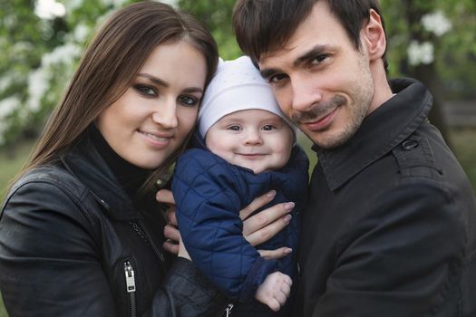 Beautiful smiling faces of people. A happy young family from three persons