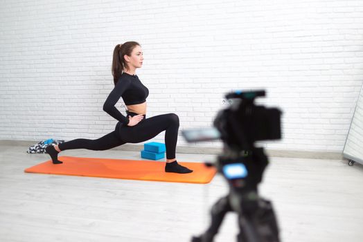 girl conducts a home workout stretching to strengthen her back