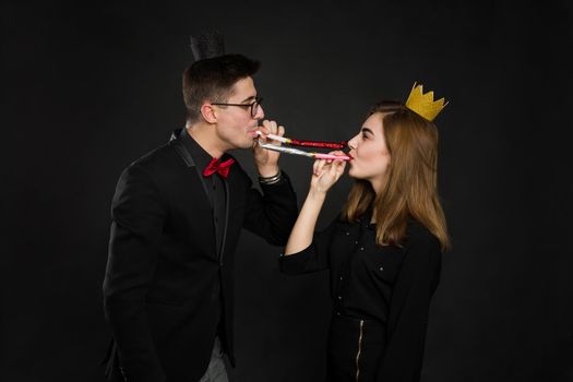 Happy couple celebrating their birthday on a brown background