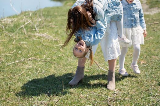 Mother and daughter have fun near a reservoir in the village.