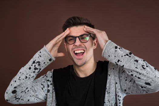 man screaming mouth open, hold head hand, isolated background, concept face emotion