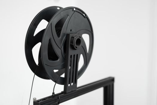 Black filament on a 3D printer in the lab
