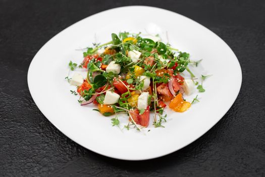 salad with fresh vegetables, microgreens and feta cheese.