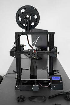 Electronic three dimensional plastic 3D printer during work in laboratory