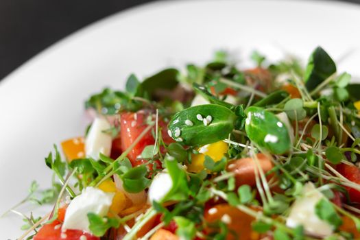 salad with fresh vegetables, microgreens and feta cheese.