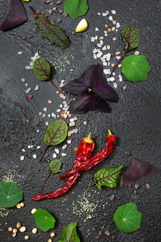 Spices and edible decor on a black background.