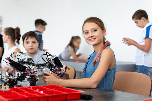 Portrait of a cute little girl in a robotics class at school