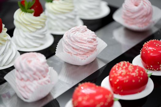 Handmade desserts are on the table in the pastry shop