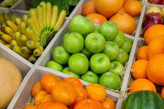 Fruits: orange, banana, apple watermelon grapes on the counter of the store