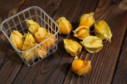Photo of yellow physalis on a wooden background