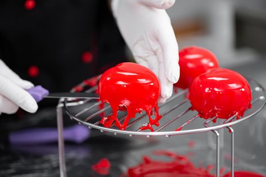 Process of making mousse cake with mirror glaze. Frozen mirror icing on the cake.