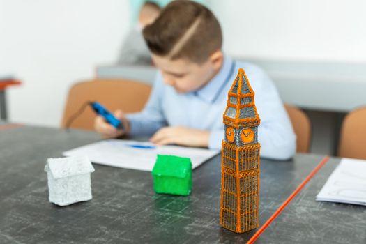 Child using 3D printing pen. Boy making new item. Creative, technology, leisure, education concept