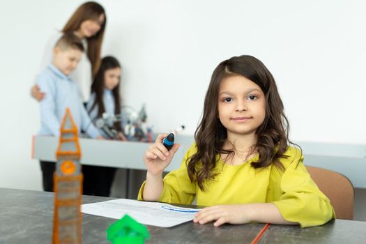 Child using 3D printing pen. Girl making new item. Creative, technology, leisure, education concept