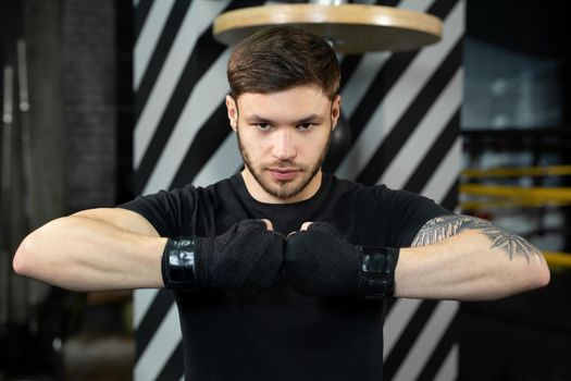 Close-up of the boxer's hand is ready to fight. The concept. Strong hands and clenched fists