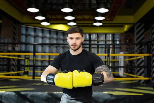 A young athlete in yellow boxing gloves