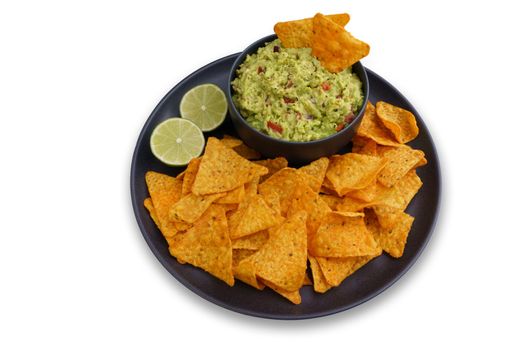 Top view of guacamole sauce and tortilla chips or nachos in black plate isolated on a white background. High quality photo