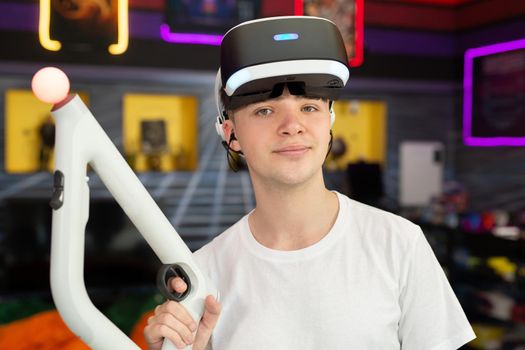 Teen, boy playing on a video game console, emotional gamer shooting a game using a gun controller in a game club. VR