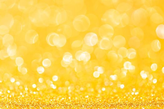 sparkles of yellow glitter abstract background. Copy space.