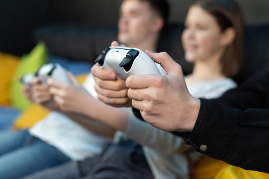 Close-up on the hands of children playing console games