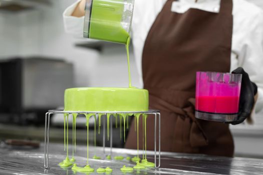 Close up woman decorating cake with glaze