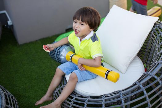 Boy with inflatable microphone at a children's birthday party.