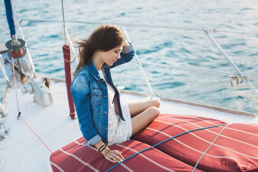 Attractive girl on a yacht at sea